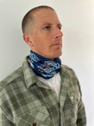 Man wearing a Reaper Rig Neck Gaiter with brand logo.